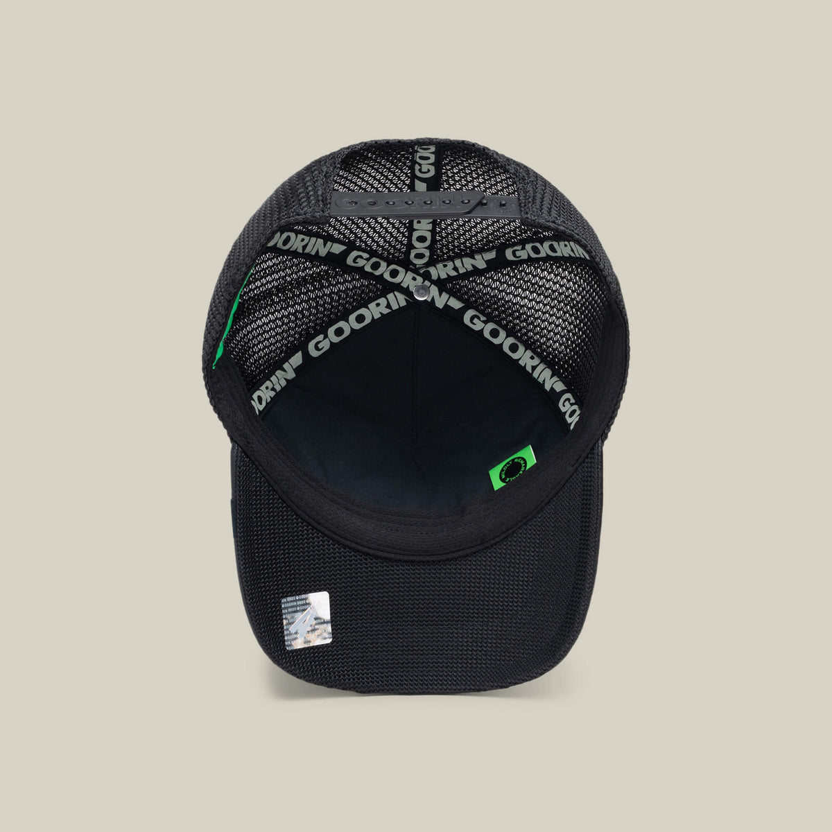 The NeoBrand STALLION by Goorin Bros. is a black mesh trucker hat featuring Goorin branding on the sweatband and a small STALLION label near the brim, with monochrome embroidery for a sleek look that pairs well with black sneakers.