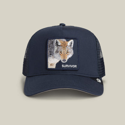 Goorin Bros. Mirage Survivor hat in EDGE color, featuring a mesh trucker design and an embroidered fox patch with the word SURVIVOR on the front panel, is displayed on a neutral background.