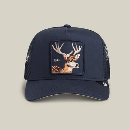 Add a playful vibe to your casual look with the Mirage Bae trucker hat by Goorin Bros. in EDGE, featuring a bold embroidered deer patch and “BAE” on the front.