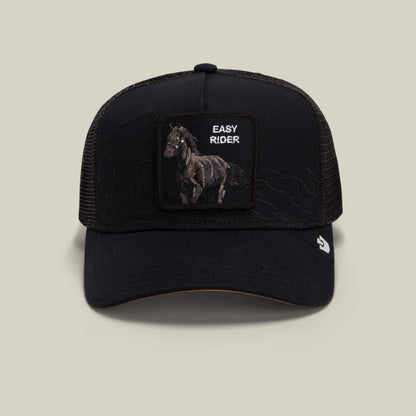 The Badlands Stallion by Goorin Bros. is a black mesh trucker hat featuring a front patch with an embroidered horse and the words EASY RIDER, a curved brim, and a small Goorin Bros. logo tag on the side.