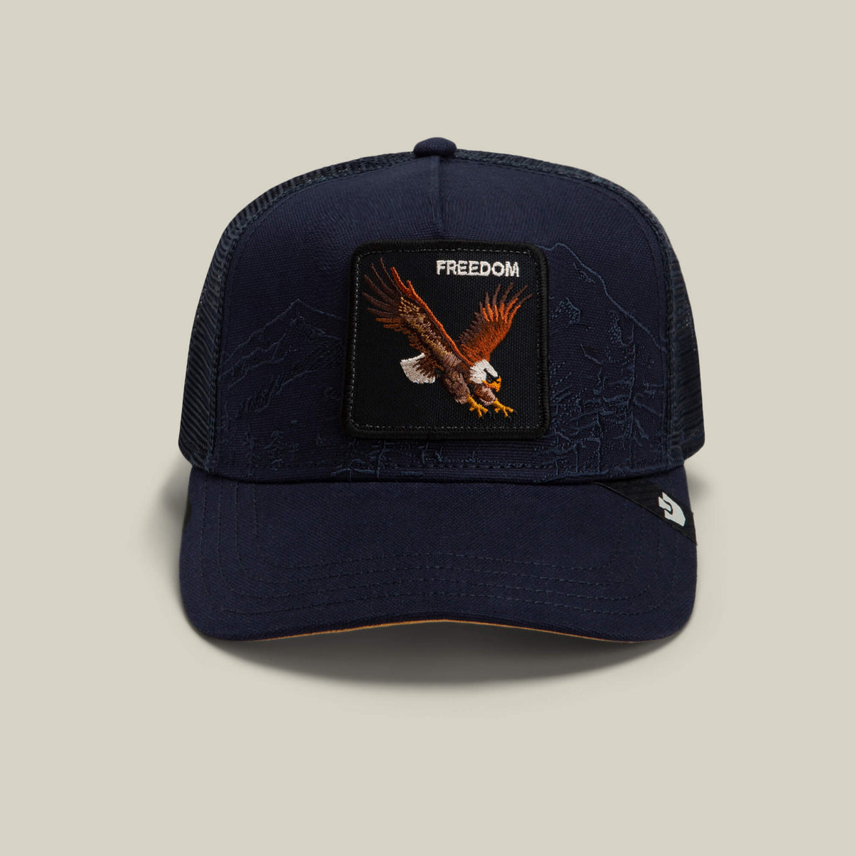 Goorin Bros. Badlands Eagle trucker hat in Edge, featuring a mesh back and a front patch with a bald eagle in flight above the word "FREEDOM.