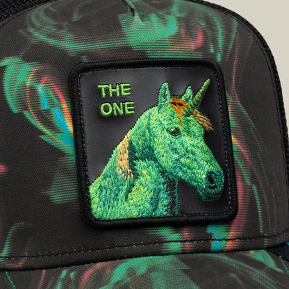 The Goorin Bros. No Spoon trucker hat features an embroidered green unicorn patch with gold accents on a black fabric base with colorful psychedelic patterns throughout.