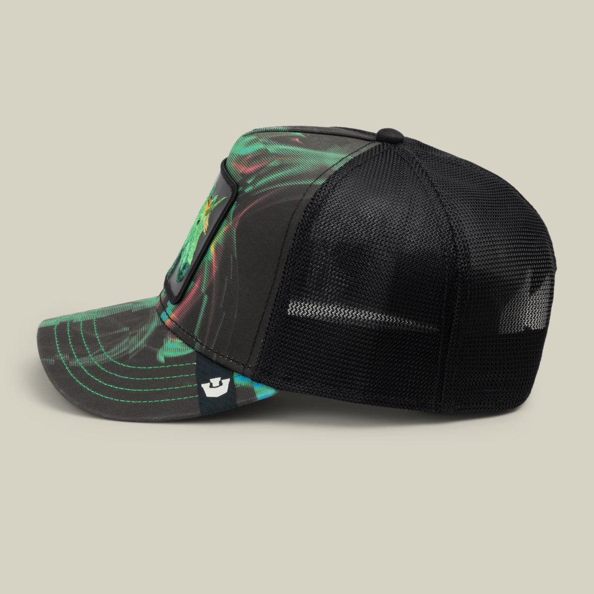 The Goorin Bros. No Spoon trucker hat features a black mesh back panel with a neon green and turquoise patterned front panel and bill, displayed against a neutral studio background.