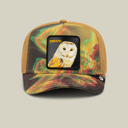 The Goorin Bros. Androids Dream trucker hat features a colorful multicolor mesh back with green, red, yellow, and gold swirls, black bill, and an embroidered white and gold owl patch labeled EMPATH on the front.
