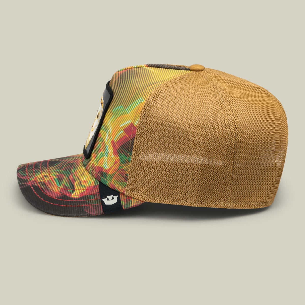 The Goorin Bros. Androids Dream trucker hat features a tan mesh back and crown with a colorful red, yellow, and green patterned front panel, shown in a studio product shot from the side view.