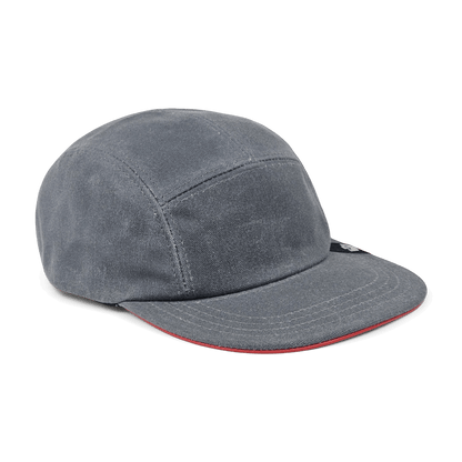 The North Boulder by Goorin Bros. is a grey cotton 5-panel camp cap with visible stitching and a slightly curved brim featuring a red underside, hand cut and sewn in the USA, shown on a white background.