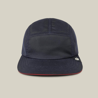 The North Boulder by Goorin Bros. is an Edge Navy 5-panel camp cap with visible stitching, a short brim, and a small right-side tag. Hand cut and sewn in the USA, it's shown on a plain beige background.