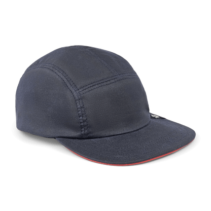 The North Boulder by Goorin Bros. is a dark navy 5-panel camp cap with visible stitching, a curved brim, and a small black side tag, hand cut and sewn in the USA, shown against a white background.
