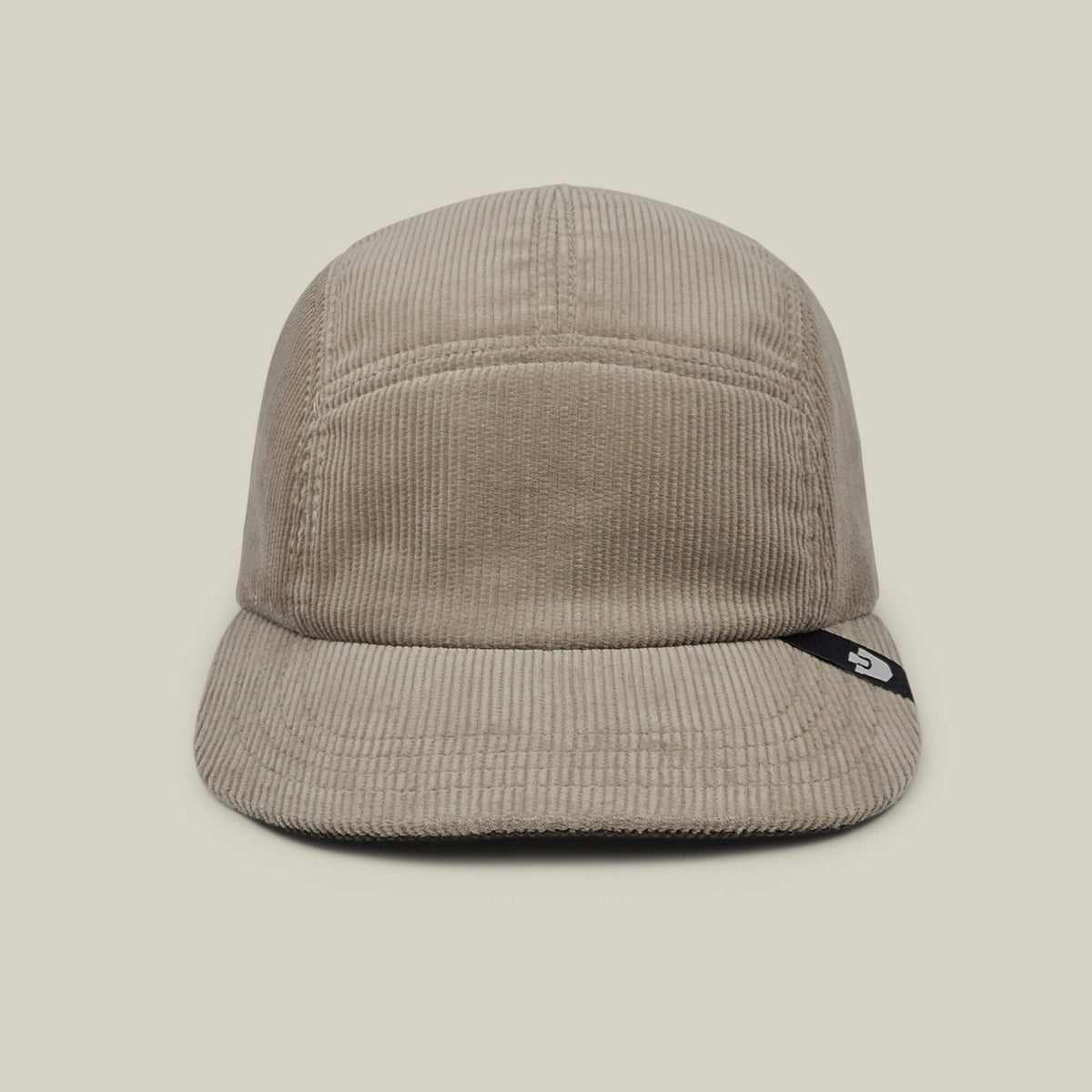 The Goorin Bros. Meadow Creek is a Toast Tan cotton corduroy 5-panel camp cap with a short brim, front view, and a small black tag with white logo on the brim's side. Made in USA.