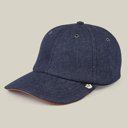 The Goorin Bros. Legend Ridge is a dark blue denim baseball cap featuring a curved brim, ventilation eyelets, and a small black and white side tag, shown here against a neutral background.