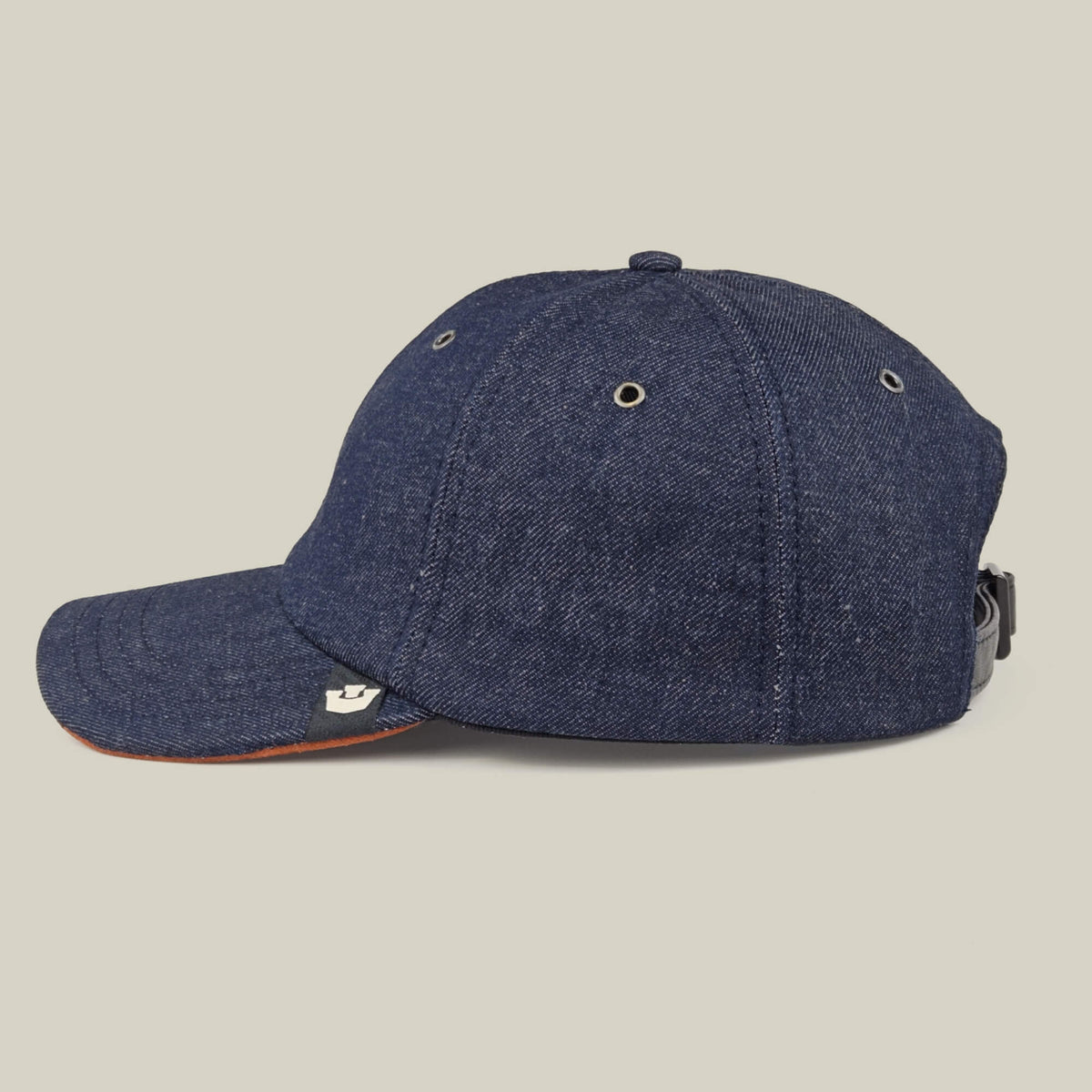 The Legend Ridge by Goorin Bros. is a mixed-material denim baseball cap featuring metal eyelets, a curved brim, and an adjustable strap. Made in the USA and shown on a neutral background.