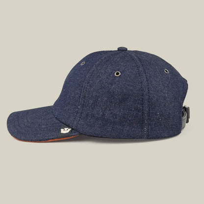 The Legend Ridge by Goorin Bros. is a mixed-material denim baseball cap featuring metal eyelets, a curved brim, and an adjustable strap. Made in the USA and shown on a neutral background.