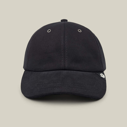 The Goorin Bros. Mineral Road cap in Void Black is hand cut and sewn with visible stitching, two metal eyelets on the front panels, and a small white logo tag on the brim, shown against a neutral background.