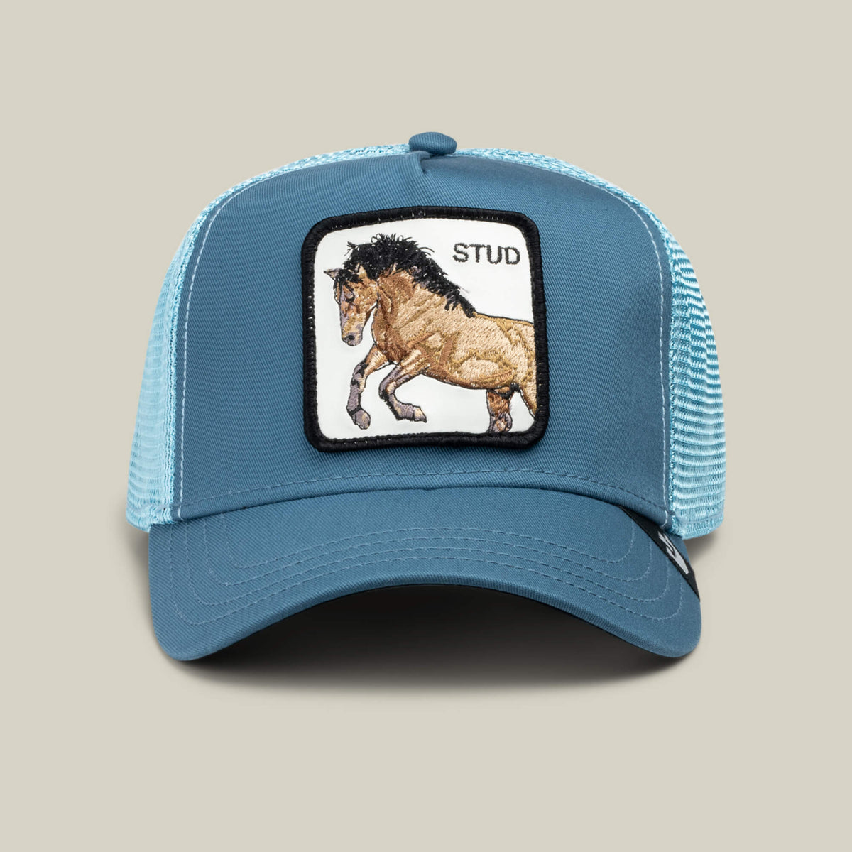 The Goorin Bros. Dad and Pony Show (Adult) hat in Air Blue is a mesh-back trucker cap featuring a patch with a running horse and "STUD" embroidered above it.