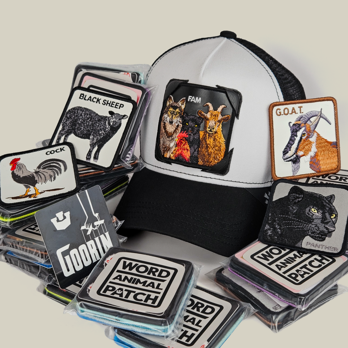 A black and white Family Patch Pack with GB Patch Corner Trucker hat featuring a patch of a wolf, cat, and goat, surrounded by various animal-themed Patch Corners.