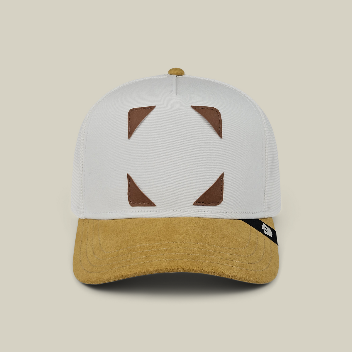Throwback Patch Pack with GB Patch Corner Trucker - Tan hat with a white crown, tan brim, and four brown triangular patch corners on the front panels.