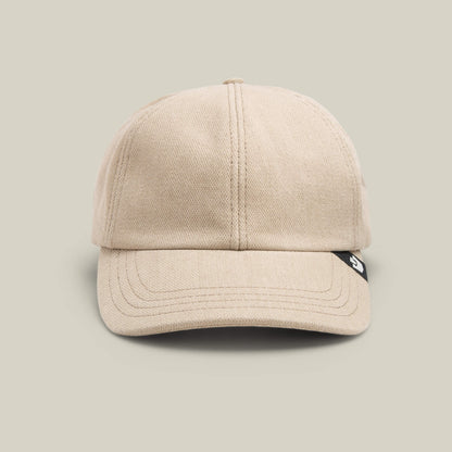 The Noisy Tailored Baseball cap by Goorin Bros. in BISCUIT features visible stitching, a black tag on the right brim, and a front-facing design—perfect for those who value subtle confidence and color-driven style.