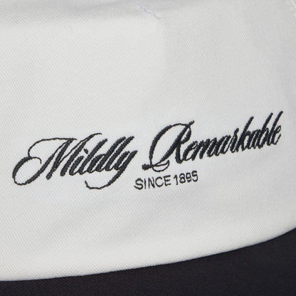Close-up of white fabric featuring the Goorin Bros. Mildly Remarkable Script embroidery, "Mildly Remarkable SINCE 1895," evoking the timeless style of a classic Scrip hat.