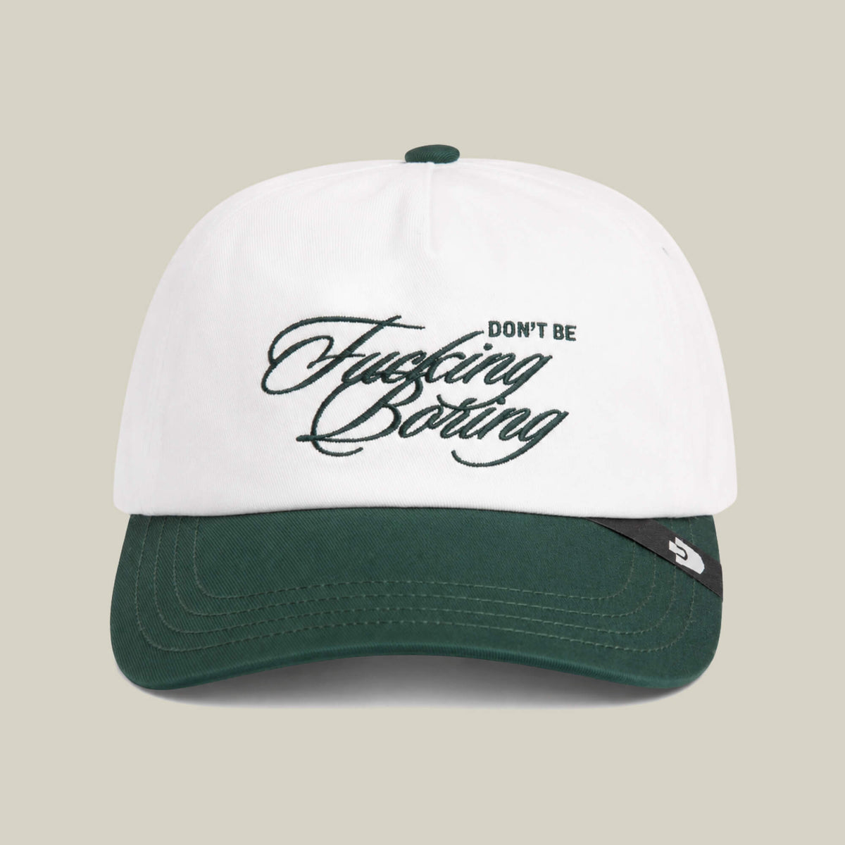 A Goorin Bros. "Don't Be Fucking Boring" cap in Dust/Palm with the slogan embroidered in cursive on the front.