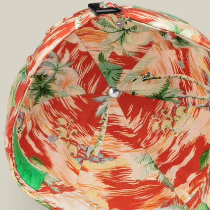 A close-up, top-down view of the inside of a red tropical-patterned Goorin Bros. Funemployed Forever papa cap, featuring palm trees, horses, and a green tag on the inner band—a fresh Friday drop.