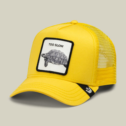The Goorin Bros. Down Low… is a yellow trucker cap with a mesh back, featuring a patch that displays a turtle and the words “TOO SLOW”—a true badge of honor for those who proudly embrace life’s elusive drop in the fast lane.