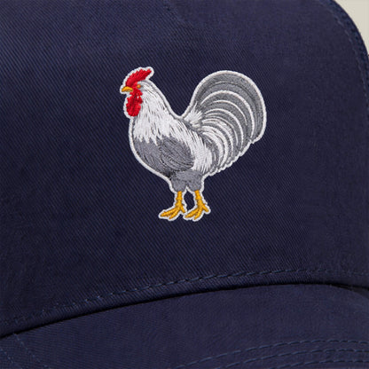 The Goorin Bros. Gone Cockmaxxing is a navy blue, full-size hat featuring an embroidered rooster in white, grey, yellow, and red—an instantly recognizable statement piece.