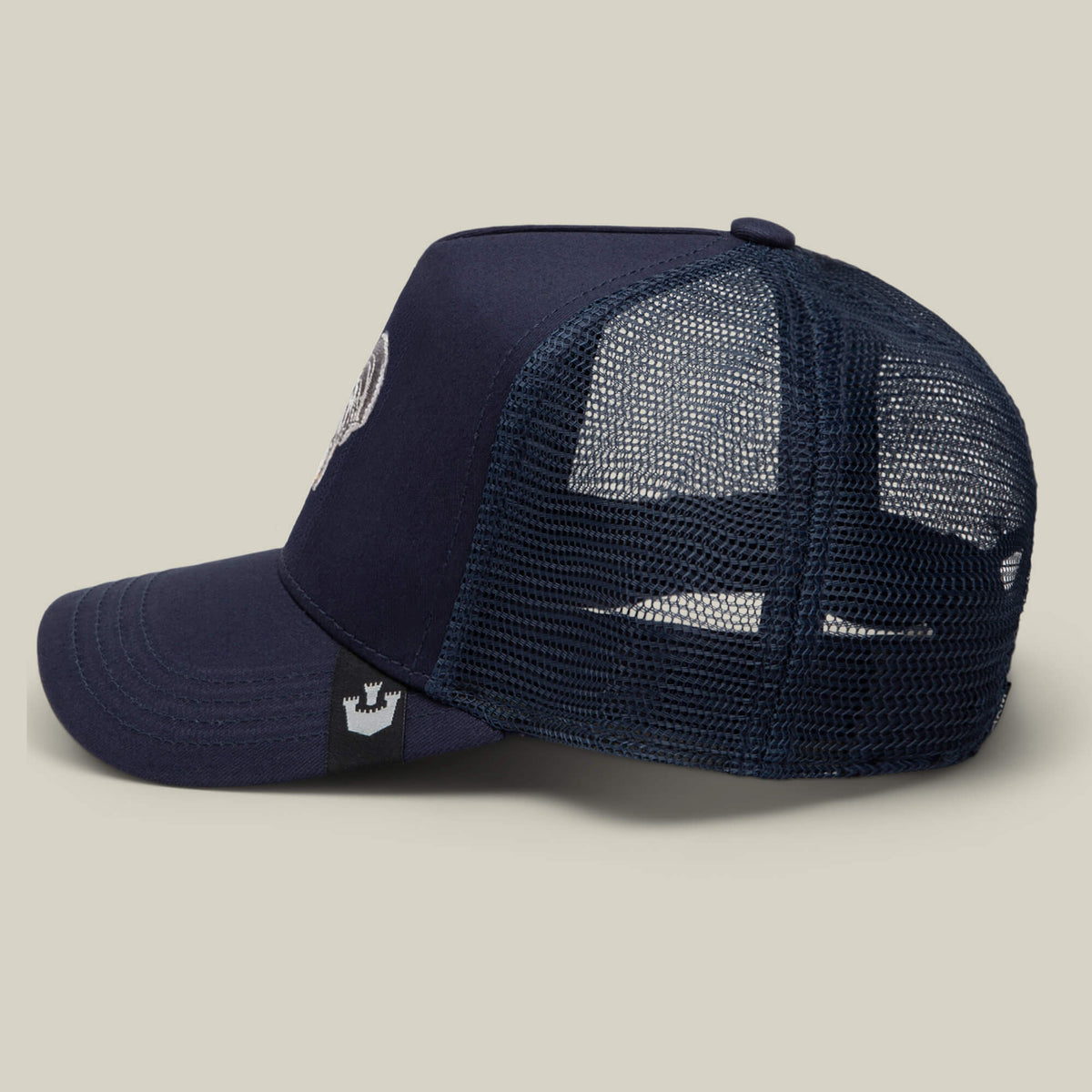 The Gone Cockmaxxing trucker hat by Goorin Bros. features a navy blue design, mesh back panel, and adjustable snap closure. This full-sized hat is shown from the side on a plain background.