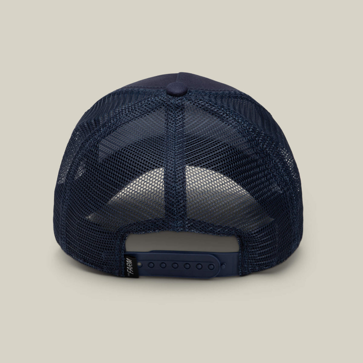 A rear view of the Goorin Bros. 1845 Goat trucker cap in navy blue mesh, featuring an adjustable snap closure and a small black tag on the strap.