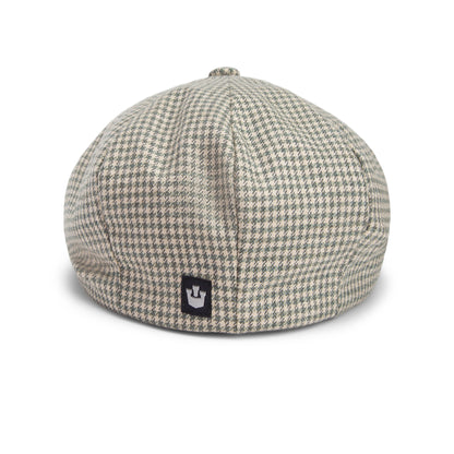 A stylish houndstooth-patterned beret hat from Goorin Bros. called Ham Bone, featuring a small black patch with a white crown logo on the back. All sales are final.