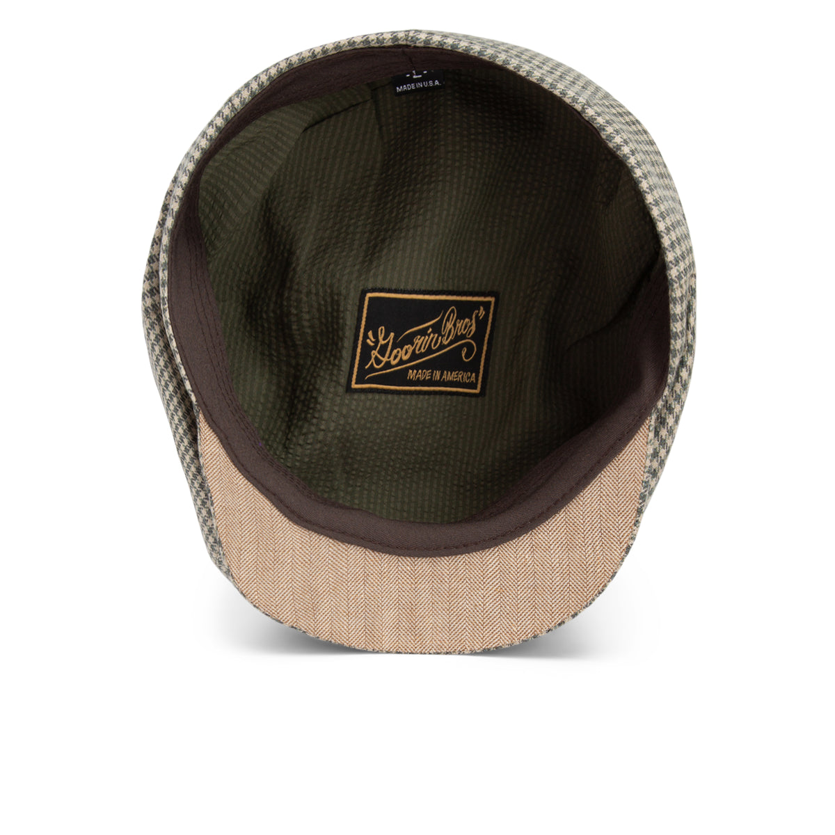 Interior view of a checkered flat cap hat, showing a brown label that reads Goorin Bros., Ham Bone. All Sales Are Final.