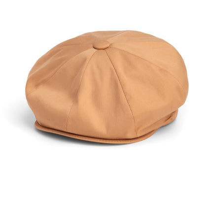 The “Chopping Block” newsboy cap by Goorin Bros. is crafted from smooth fabric in tan, featuring panel stitching and a button on top for a distinctive shape, displayed against a white background.