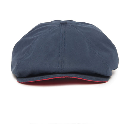 A navy blue Mulberry Street flatcap by Goorin Bros. features visible stitching, a slightly curved brim, and a thin red accent under the edge of the brim for a stylish touch.
