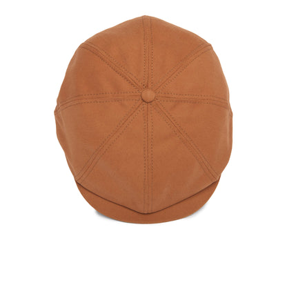 The Mulberry Street flatcap by Goorin Bros. is shown from above, highlighting stitching lines that radiate from a central button. This stylish flatcap features a short, curved brim and is crafted from soft cotton fabric.