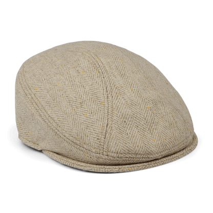 The Iris Fields flatcap by Goorin Bros. features cream herringbone wool, a rounded crown, and a short stiff brim. Hand sewn in the USA and shown against a white background.
