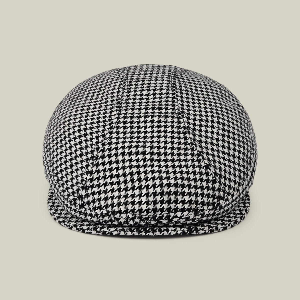The Norwood flatcap by Goorin Bros., in Void Black and Dust White houndstooth, made in the USA, is shown front-facing against a plain beige background.