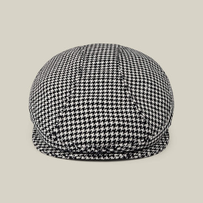 The Norwood flatcap by Goorin Bros., in Void Black and Dust White houndstooth, made in the USA, is shown front-facing against a plain beige background.