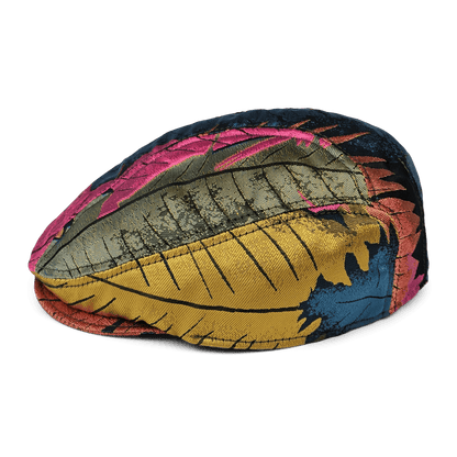 The Upland Avenue flatcap by Goorin Bros. features a vibrant leaf pattern in gold, blue, pink, and green on white fabric, and is hand sewn in the USA.