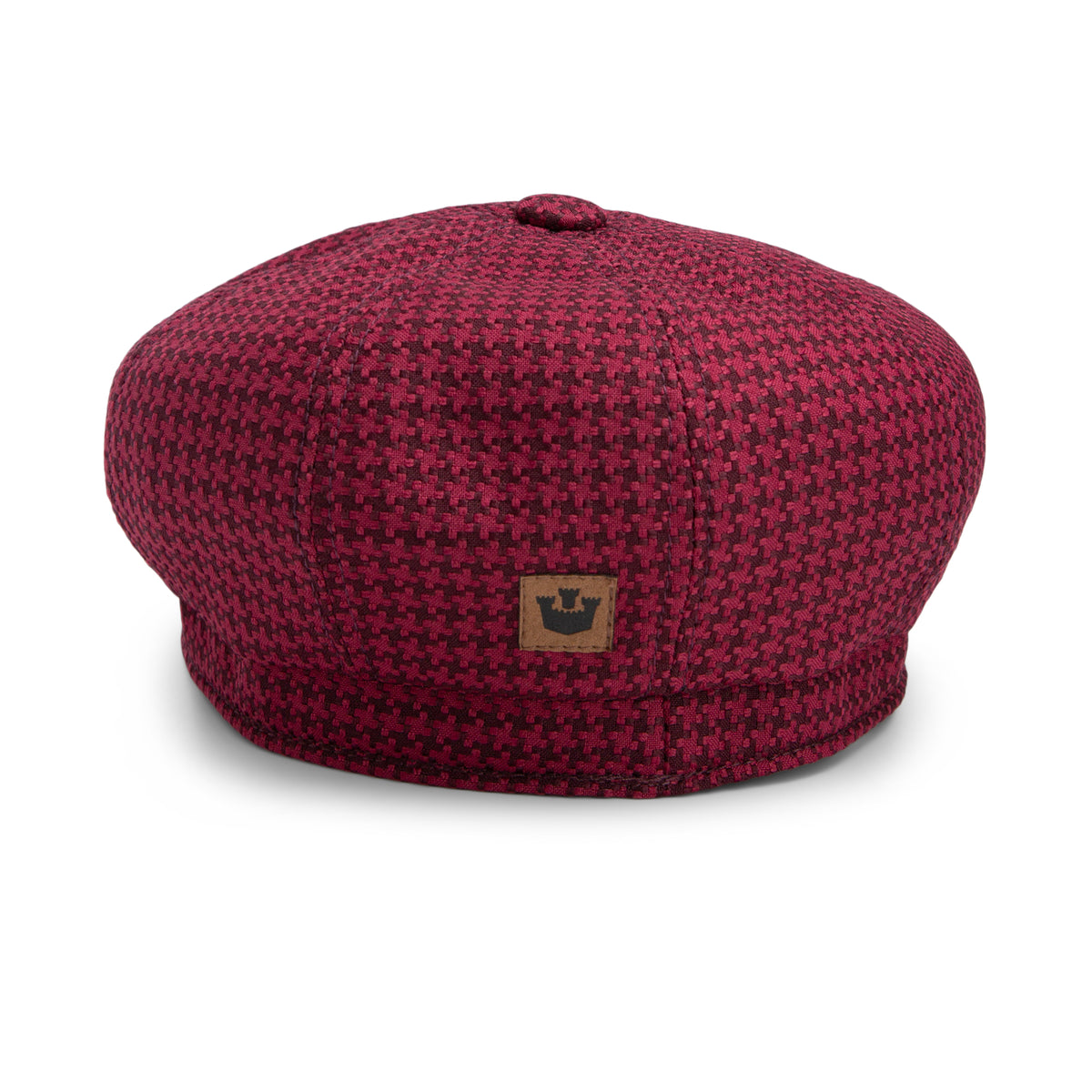 The Cold Snap by Goorin Bros. is a red and black houndstooth patterned beret, featuring a small brown patch with a black crown logo on the front and crafted with a German wicking sweatband for added comfort.
