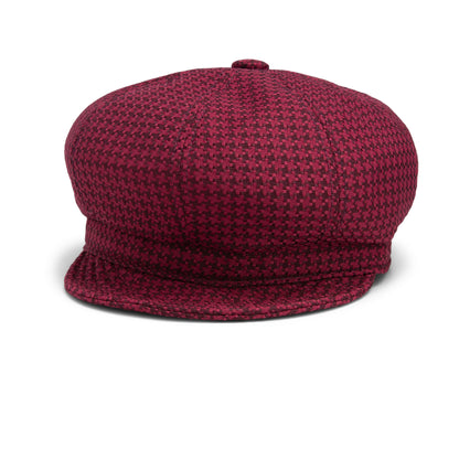 The Goorin Bros. Cold Snap cabbie flatcap, displayed from the front on a plain white background, features a red and black houndstooth pattern and is equipped with a German wicking sweatband for enhanced comfort.