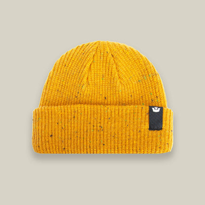 The No Comply beanie by Goorin Bros. is a warm yellow knit hat with a folded brim and a small black rectangular tag on the front—stylish comfort for chilly days, shown on a neutral background.