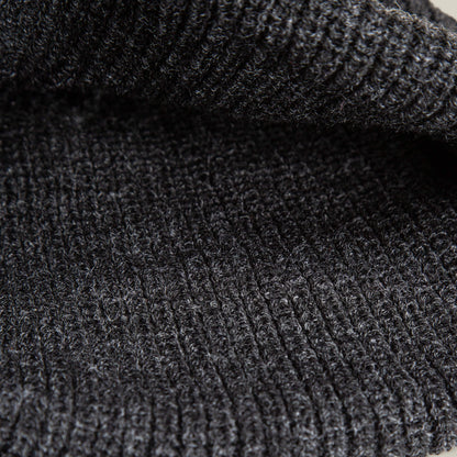 Close-up of the dark gray, ribbed knit fabric of The Panther Beanie by Goorin Bros., showcasing its soft texture and visible horizontal ridges—perfect for a warm, stylish beanie.