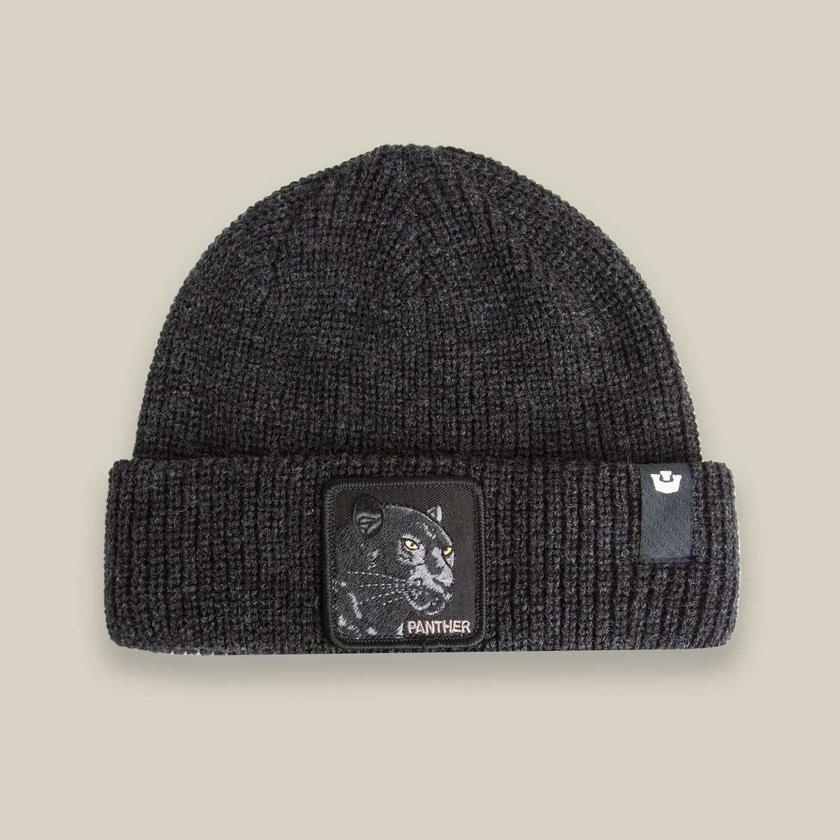 The Panther Beanie by Goorin Bros. in VOID features a folded brim, panther patch, and PANTHER text on the front—blending style and comfort for all seasons.