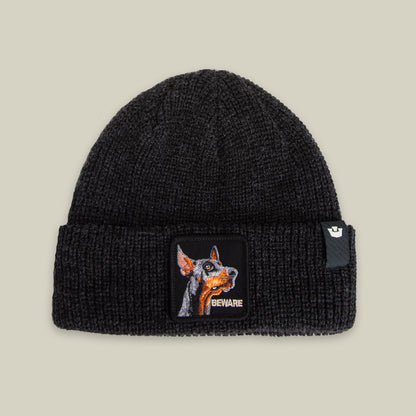 The Beware Beanie by Goorin Bros. in VOID features a heavyweight knit and a front cuff patch with a dog's face and "BEWARE"—ideal for those seeking a bold, guard dog-inspired accessory.