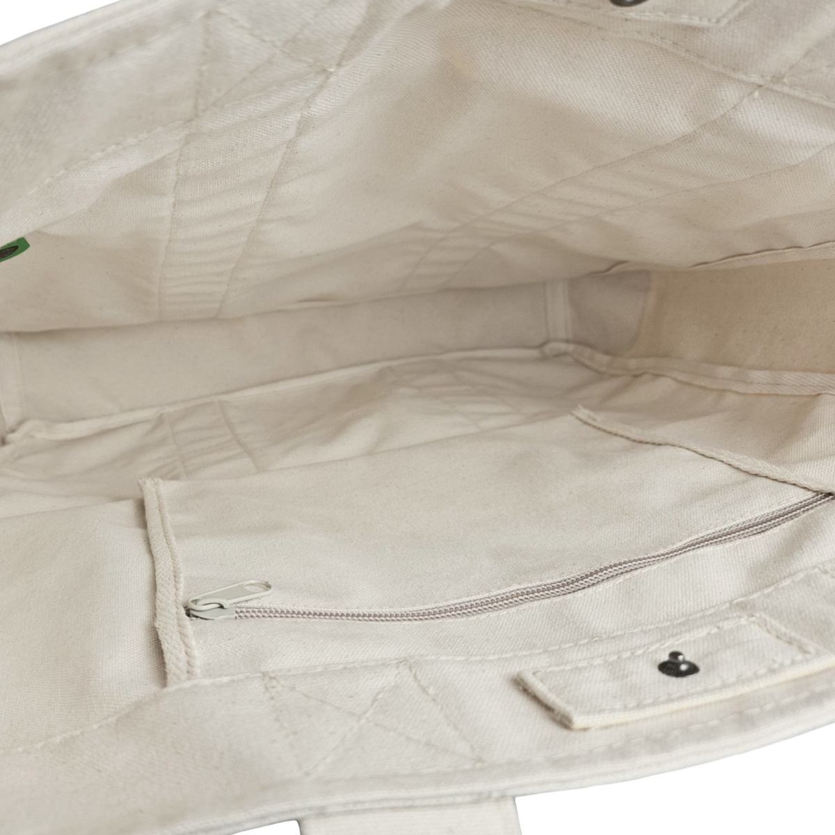 The Goorin Reworked Tote by Goorin Bros. is made in the USA and features a beige canvas lining, interior zippered pocket, and snap button pocket.