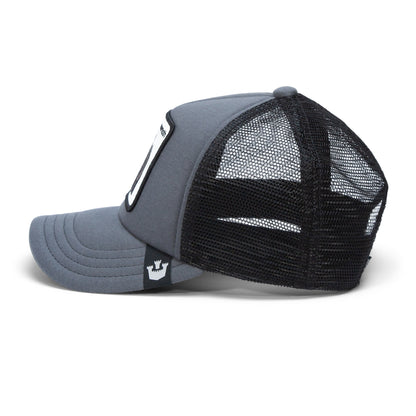 A gray and black mesh child-sized trucker hat from The Farm’s Fuzzy Trunk line lies on its side, featuring a curved brim, mesh back panels, and a small crown logo tag on the side. This adjustable hat offers a comfortable fit for kids.
