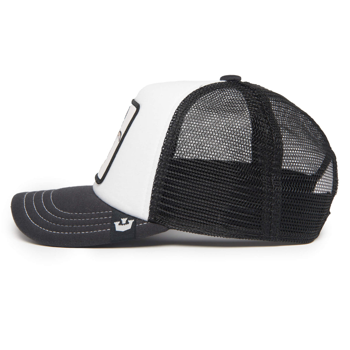 A side-view image of The Farm’s Tuxie, a black and white trucker hat featuring a curved black brim, a white front panel, and a mesh back. This adjustable hat comes in children’s sizes for the perfect fit.