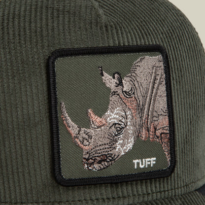 Close-up of the Goorin Bros. Corduroy Tuff hat—a green corduroy trucker cap crafted from a durable polyester-cotton blend, featuring a square embroidered patch with a rhinoceros and the word “TUFF” in white text.
