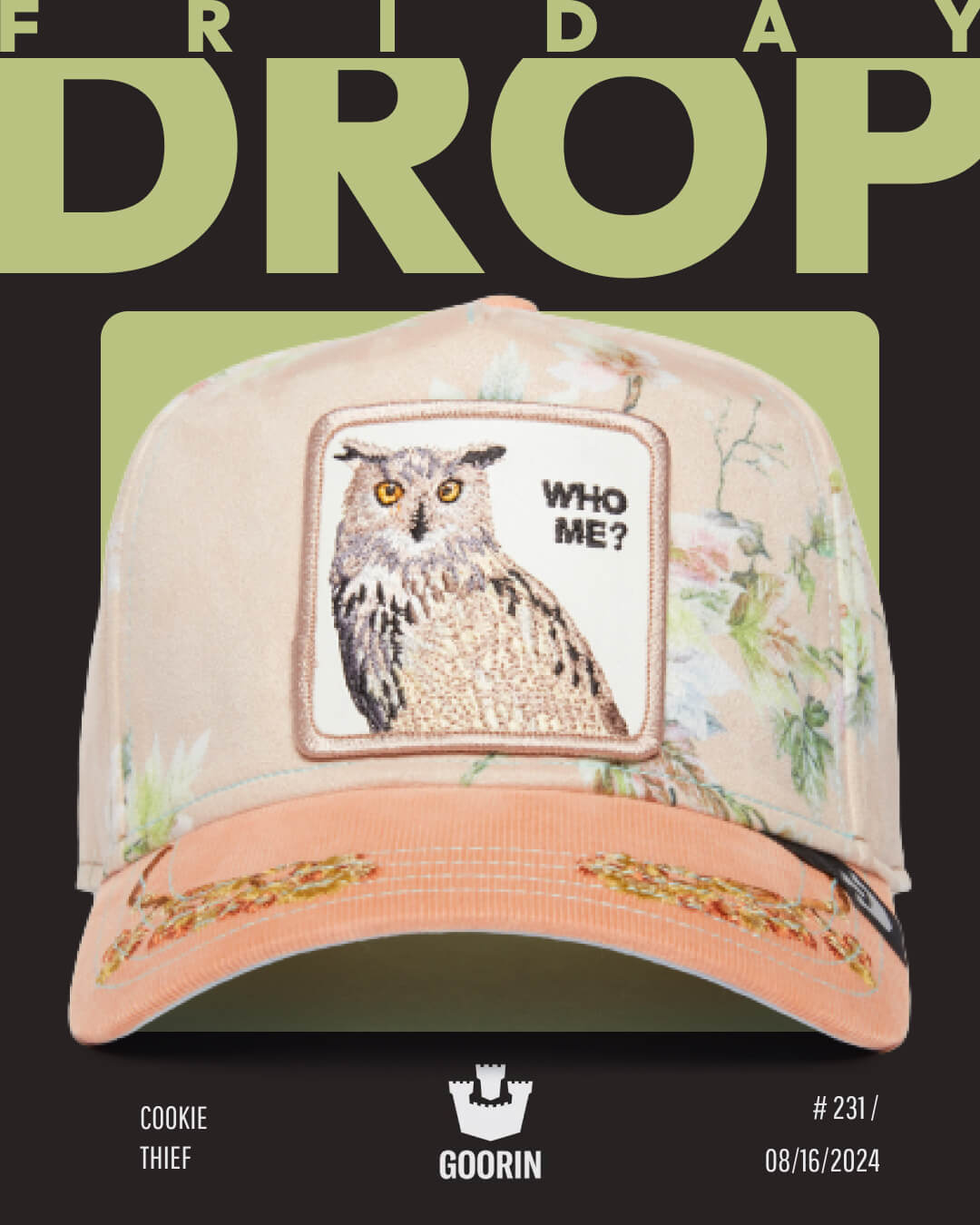 A beige floral cap by Goorin, featuring an embroidered owl patch labeled WHO ME?, is displayed against a black and green background with the text FRIDAY DROP.