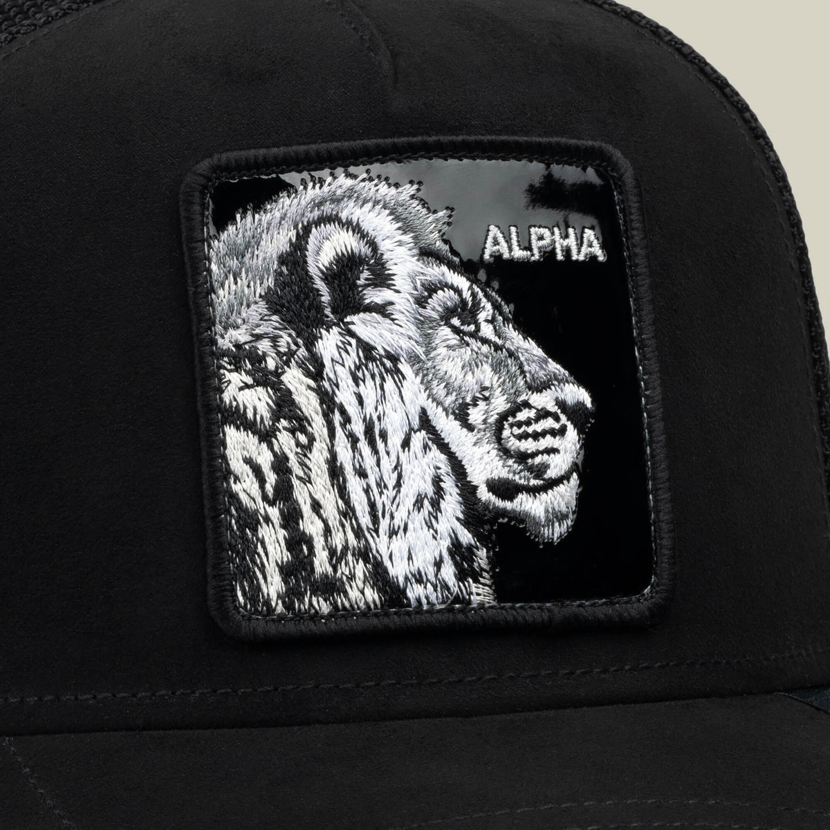 The Black Out Lion hat by Goorin Bros. is a black mesh trucker hat featuring a bold embroidered patch with a lion’s head and the word “ALPHA” in white, combining striking design with classic stealth style.