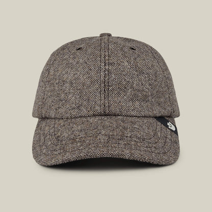The Goorin Bros. Valmont is a brown textured wool baseball cap with a curved brim and a black tag on the right side, made in the USA and shown against a plain beige background.